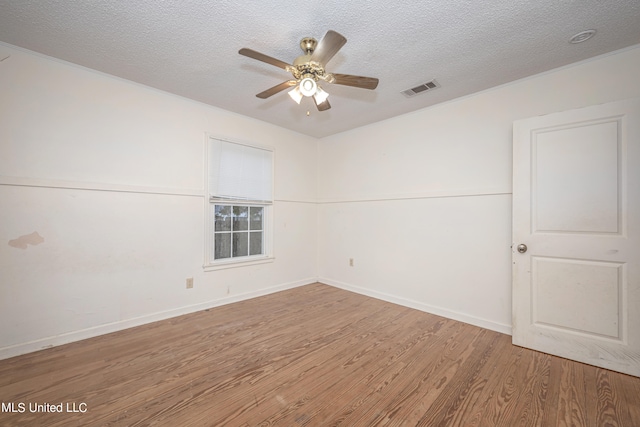 spare room featuring a textured ceiling, hardwood / wood-style flooring, and ceiling fan