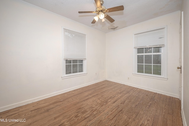 spare room with ceiling fan, hardwood / wood-style flooring, and a textured ceiling