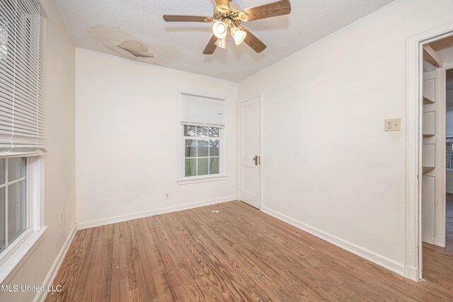 spare room with ceiling fan, hardwood / wood-style flooring, and a textured ceiling