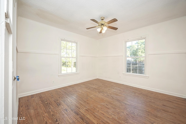 2411 12th St, Pascagoula, MS 39567 - empty room featuring ceiling fan, wood finished floors, and a textured ceiling