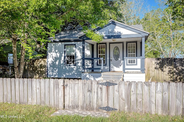 2411 12th St, Pascagoula, MS 39567 - view of front of home with roof with shingles and covered porch