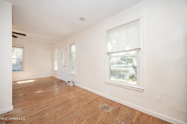 2411 12th St, Pascagoula, MS 39567 - empty room with wood finished floors, healthy amount of natural light, and ceiling fan