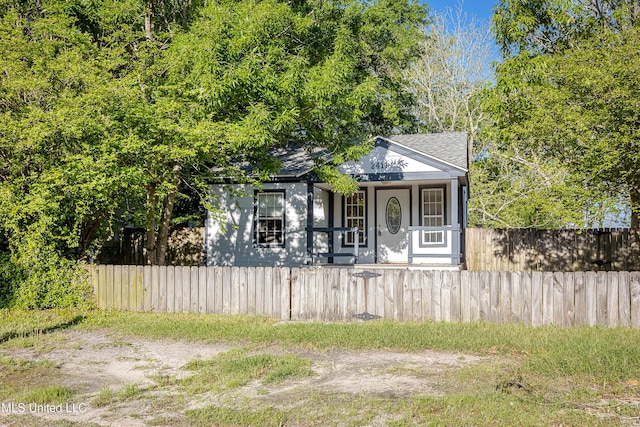 2411 12th St, Pascagoula, MS 39567 - view of front of property with a fenced front yard and roof with shingles