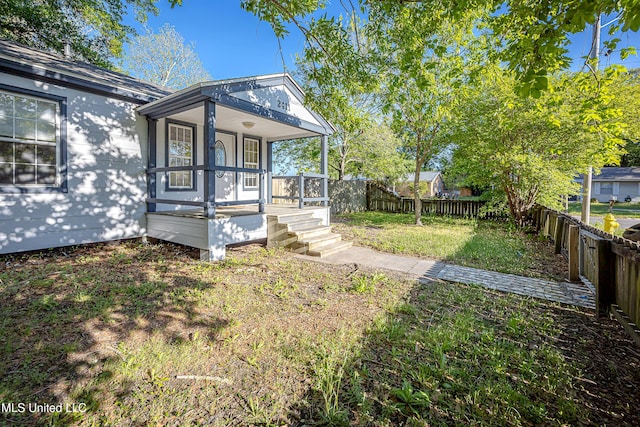 2411 12th St, Pascagoula, MS 39567 - fenced backyard featuring covered porch