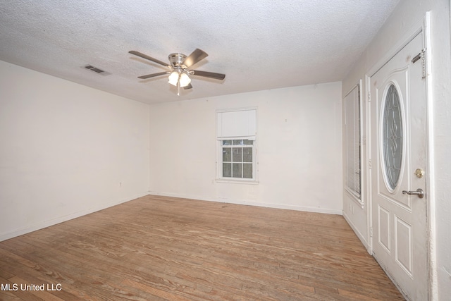 entrance foyer featuring a textured ceiling, light wood-type flooring, and ceiling fan