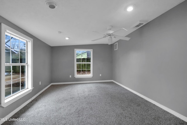 carpeted empty room featuring baseboards, visible vents, and a ceiling fan