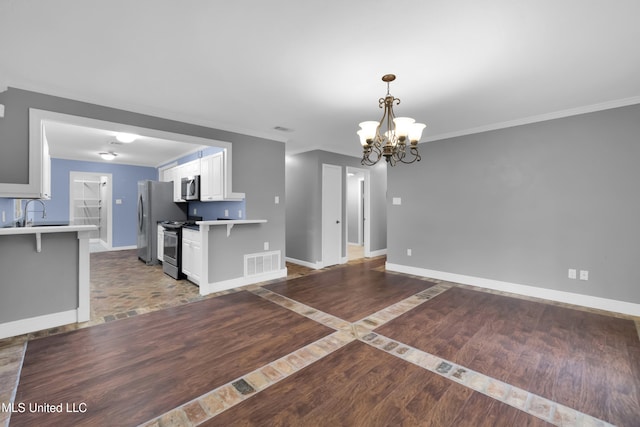 kitchen featuring a chandelier, stainless steel appliances, visible vents, baseboards, and light wood-type flooring