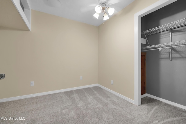 unfurnished bedroom featuring a closet, carpet flooring, a ceiling fan, and baseboards