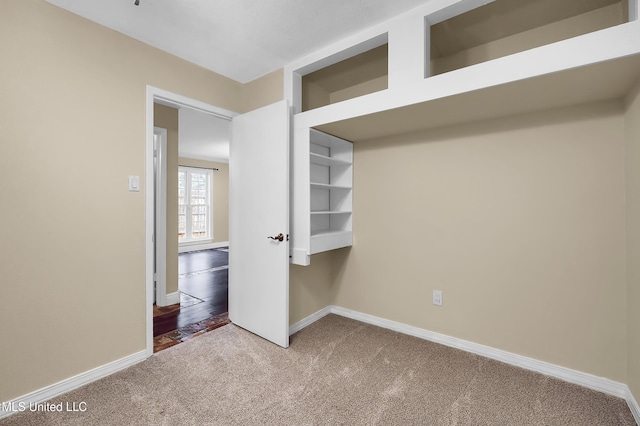 unfurnished bedroom featuring carpet flooring and baseboards