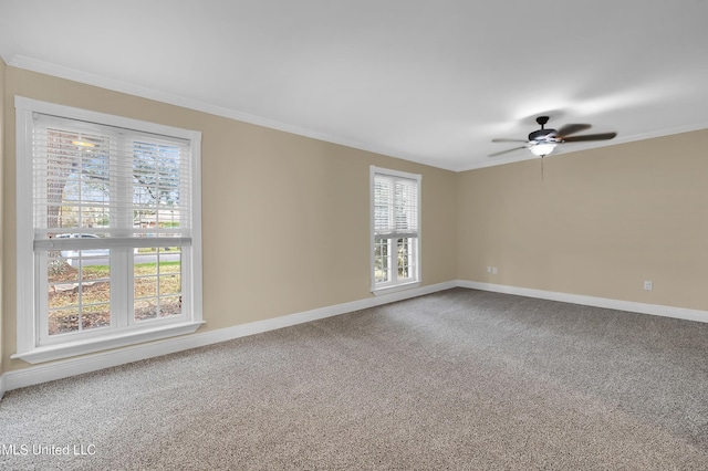 unfurnished room featuring carpet, baseboards, ceiling fan, and crown molding