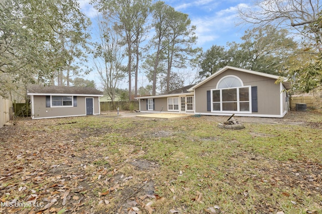 back of house featuring an outbuilding, a patio, and a fenced backyard