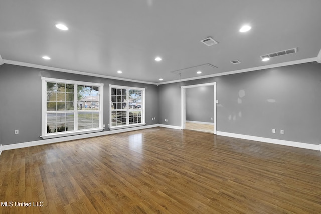 empty room with attic access, recessed lighting, visible vents, and baseboards