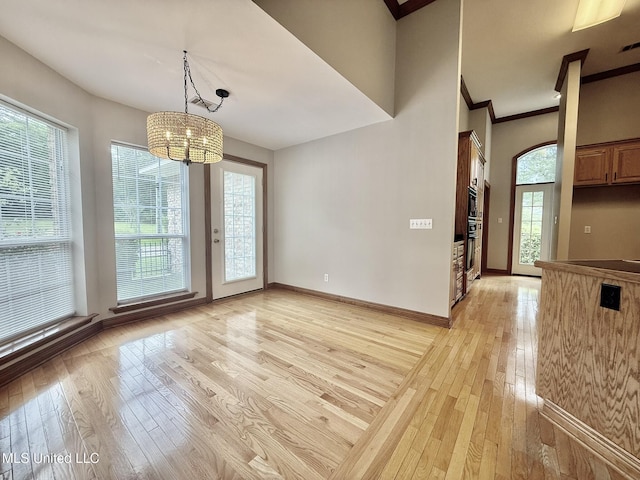 110 Frye Rd, Hattiesburg, MS 39401 - unfurnished dining area with light wood finished floors, a chandelier, baseboards, and ornamental molding