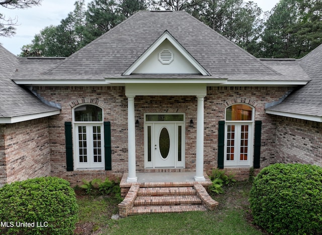 110 Frye Rd, Hattiesburg, MS 39401 - doorway to property featuring roof with shingles, brick siding, french doors, and covered porch