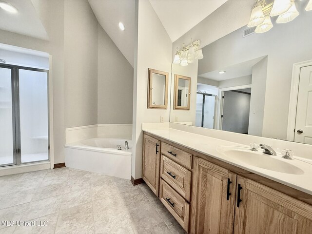 110 Frye Rd, Hattiesburg, MS 39401 - full bathroom featuring a shower stall, vanity, lofted ceiling, a garden tub, and baseboards