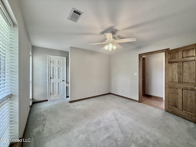 110 Frye Rd, Hattiesburg, MS 39401 - unfurnished bedroom featuring light colored carpet, baseboards, and a ceiling fan