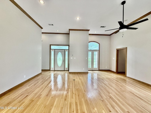 110 Frye Rd, Hattiesburg, MS 39401 - unfurnished living room featuring ornamental molding, light wood-type flooring, ceiling fan, a high ceiling, and baseboards