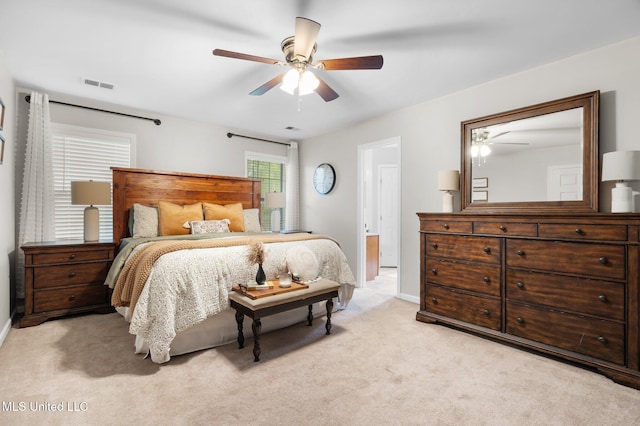 bedroom with a ceiling fan, baseboards, visible vents, and light carpet