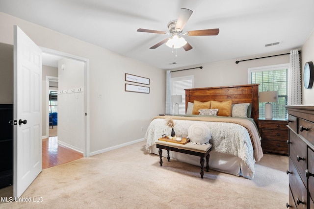 carpeted bedroom featuring baseboards and ceiling fan
