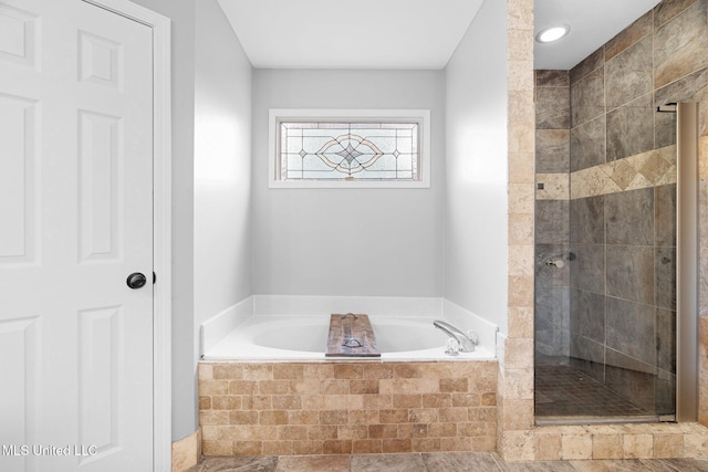 full bath with a stall shower and a garden tub