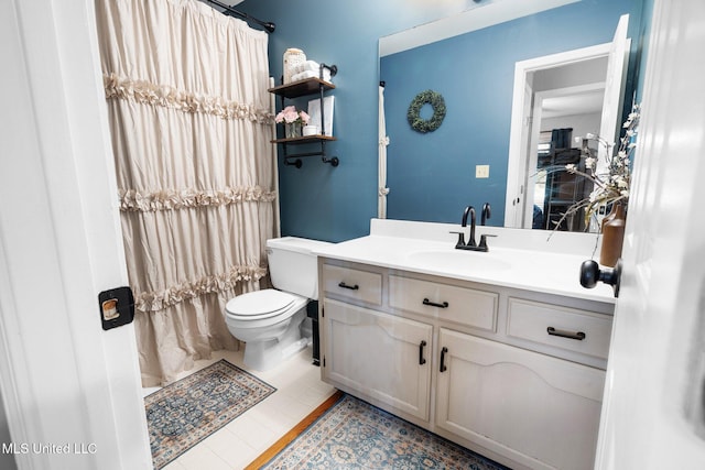 bathroom featuring toilet, a shower with curtain, tile patterned floors, and vanity