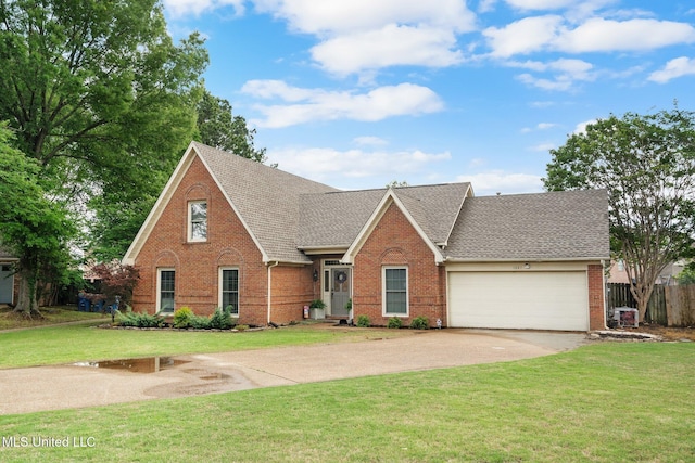 traditional-style home with an attached garage, concrete driveway, a front lawn, and brick siding