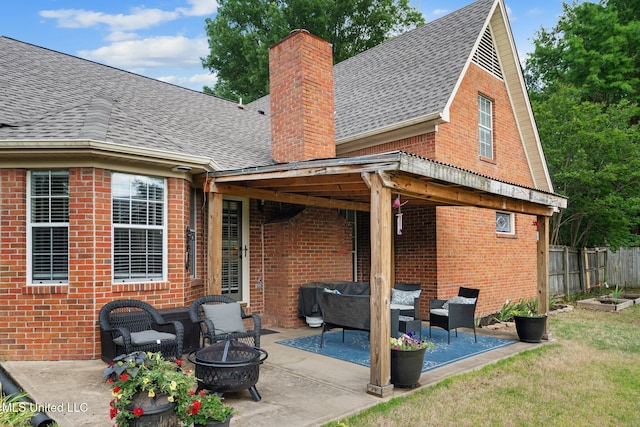 back of house with brick siding, a shingled roof, a patio, and a chimney