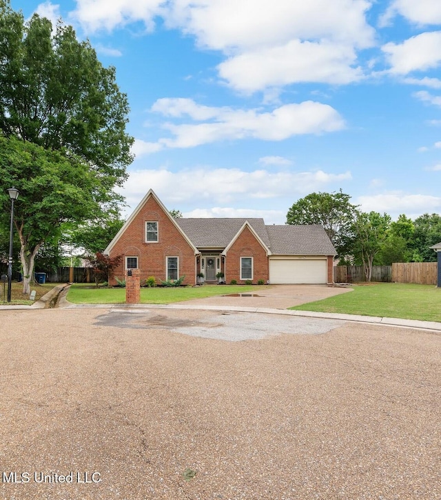 view of front of property featuring a garage, a front lawn, fence, brick siding, and driveway