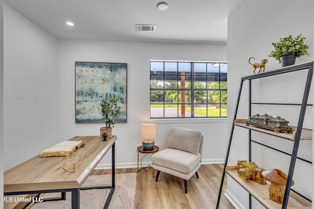 office with light hardwood / wood-style flooring