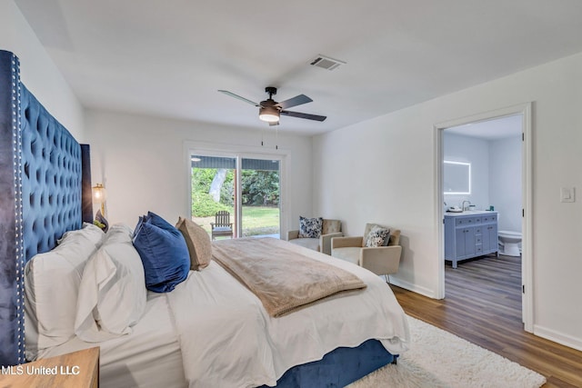 bedroom featuring ceiling fan, ensuite bathroom, dark hardwood / wood-style floors, and sink