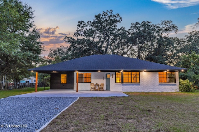 ranch-style home featuring a lawn