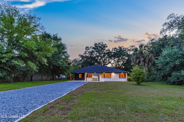 ranch-style home featuring a yard