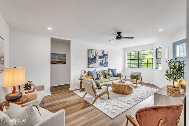 living room featuring light hardwood / wood-style floors and ceiling fan