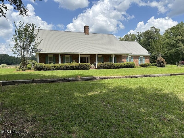 9053 Castalian Springs Rd, Durant, MS 39063 - view of front facade featuring a front lawn, a chimney, and metal roof