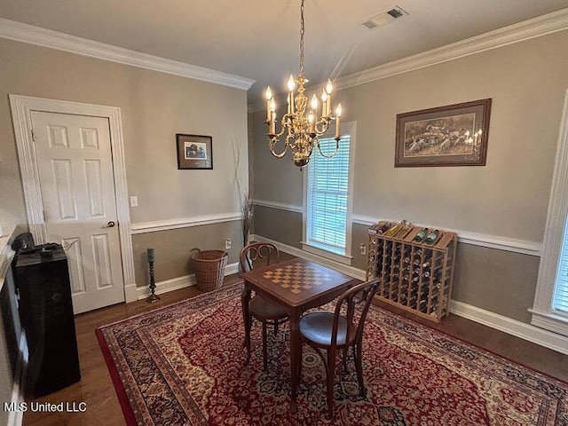 9053 Castalian Springs Rd, Durant, MS 39063 - dining area with visible vents, crown molding, wood finished floors, an inviting chandelier, and a wealth of natural light