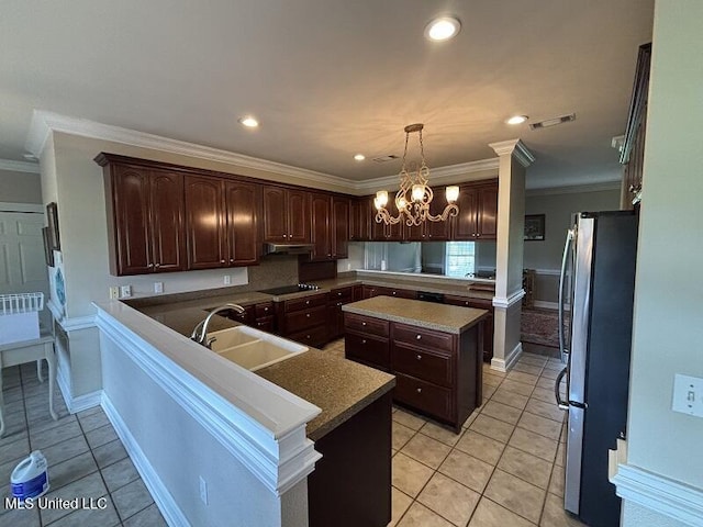 9053 Castalian Springs Rd, Durant, MS 39063 - kitchen with dark brown cabinets, a sink, light tile patterned floors, freestanding refrigerator, and black electric stovetop