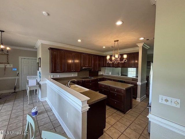 9053 Castalian Springs Rd, Durant, MS 39063 - kitchen featuring a sink, dark brown cabinetry, and a notable chandelier
