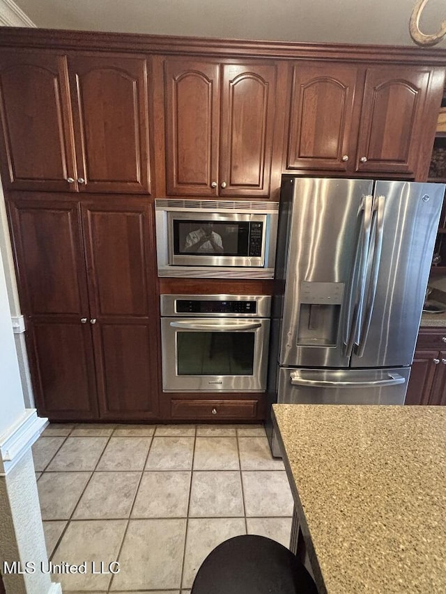9053 Castalian Springs Rd, Durant, MS 39063 - kitchen with light countertops, light tile patterned floors, and stainless steel appliances