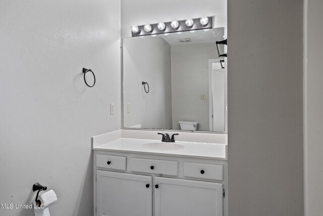 bathroom with toilet and vanity