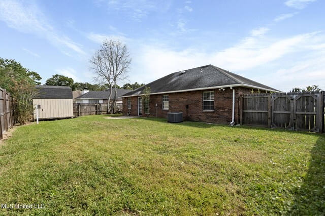 view of yard with a shed and central AC