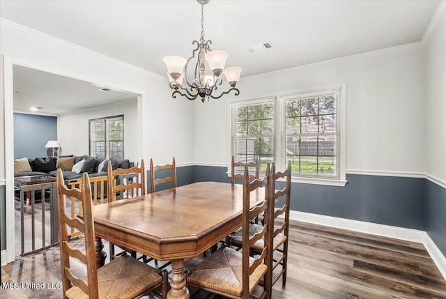 78 Bayou Cir, Gulfport, MS 39507 - dining space with wood finished floors, a chandelier, baseboards, and crown molding