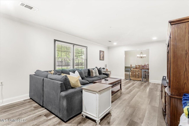 78 Bayou Cir, Gulfport, MS 39507 - living room featuring a chandelier, light wood-style floors, ornamental molding, baseboards, and recessed lighting