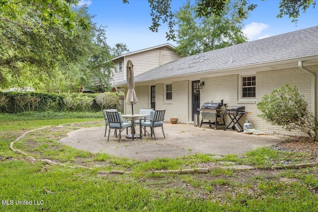 78 Bayou Cir, Gulfport, MS 39507 - back of property featuring brick siding, a patio area, and roof with shingles