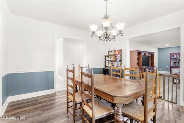 78 Bayou Cir, Gulfport, MS 39507 - dining room with a chandelier, wood finished floors, baseboards, and crown molding