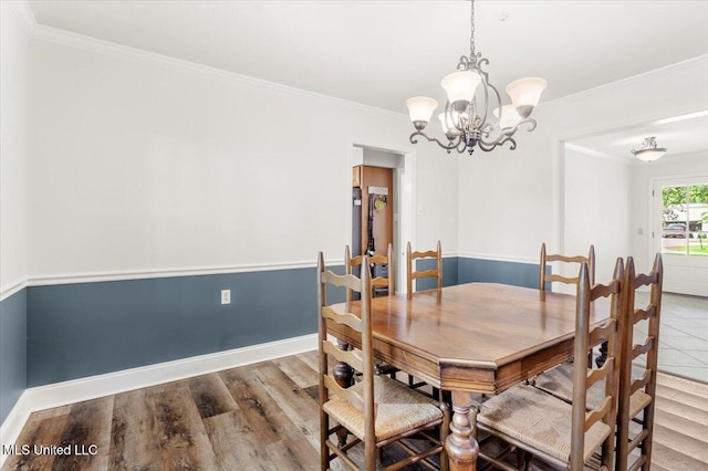 78 Bayou Cir, Gulfport, MS 39507 - dining area with baseboards, ornamental molding, wood finished floors, and a chandelier