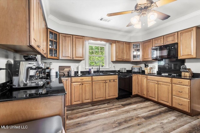 78 Bayou Cir, Gulfport, MS 39507 - kitchen with black appliances, a sink, dark countertops, brown cabinets, and crown molding