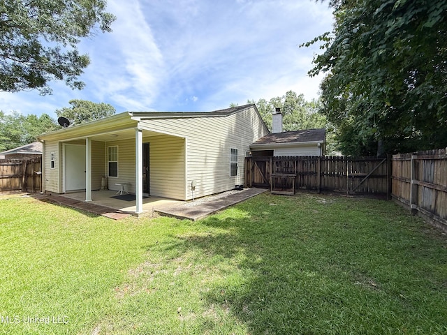 999 Hamakua St, Diamondhead, MS 39525 - rear view of property with a fenced backyard, a patio area, and a gate