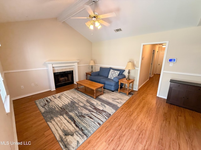 999 Hamakua St, Diamondhead, MS 39525 - living area with wood finished floors, a ceiling fan, and a tiled fireplace