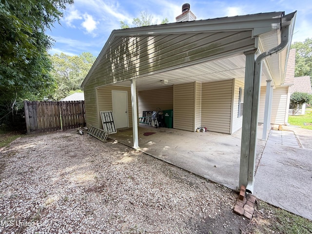 999 Hamakua St, Diamondhead, MS 39525 - view of parking / parking lot featuring an attached carport and driveway