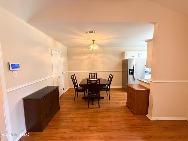 999 Hamakua St, Diamondhead, MS 39525 - dining room with a chandelier and light wood-type flooring